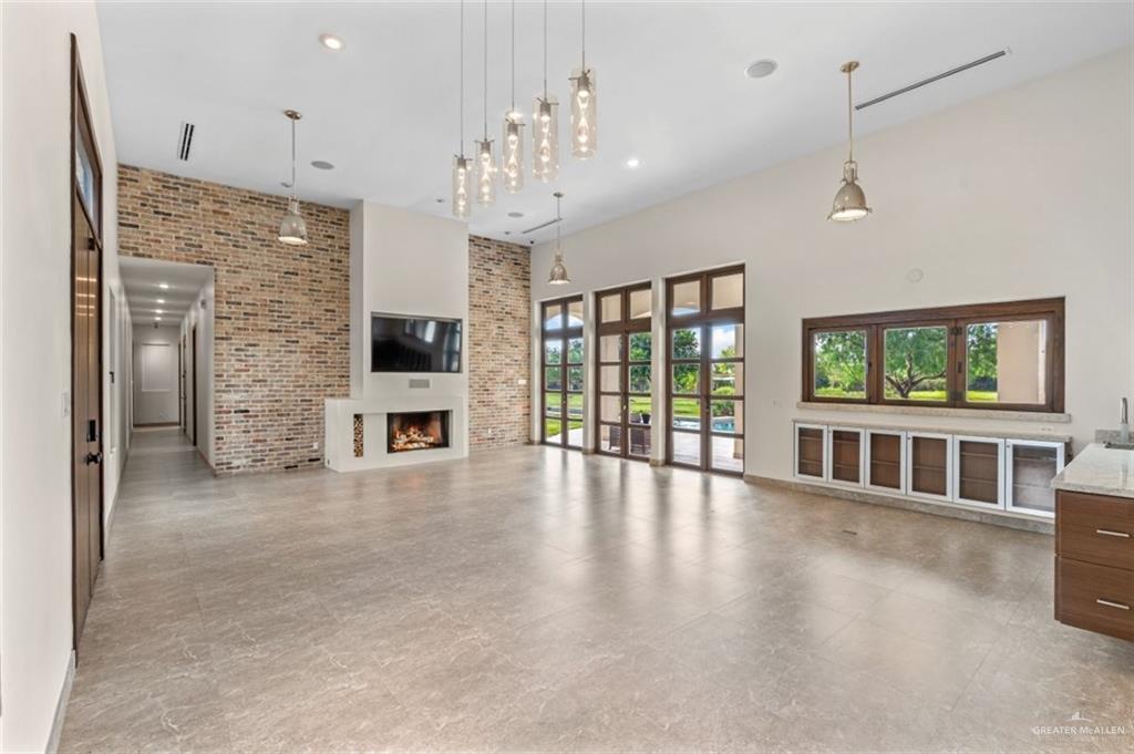 1425 Encanto Road, Unit SERVICE Weslaco, TX 78596 - Photo 33 of 45 View from Kitchen to living and dining areas with high ceiling s