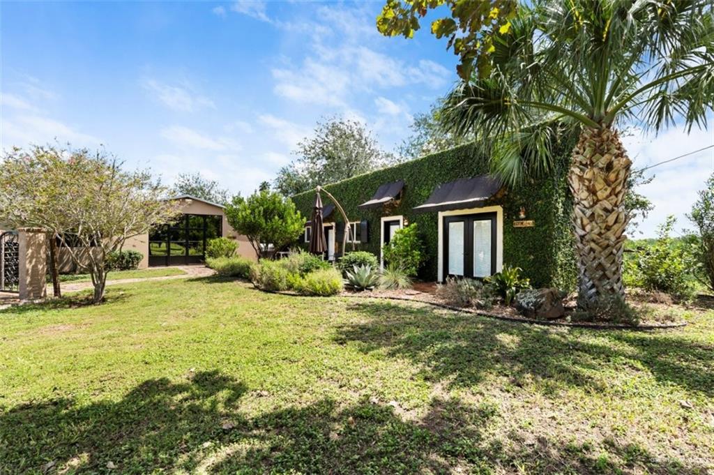 1425 Encanto Road, Unit SERVICE Weslaco, TX 78596 - Photo 37 of 45 View of grassy yard featuring a sunroom