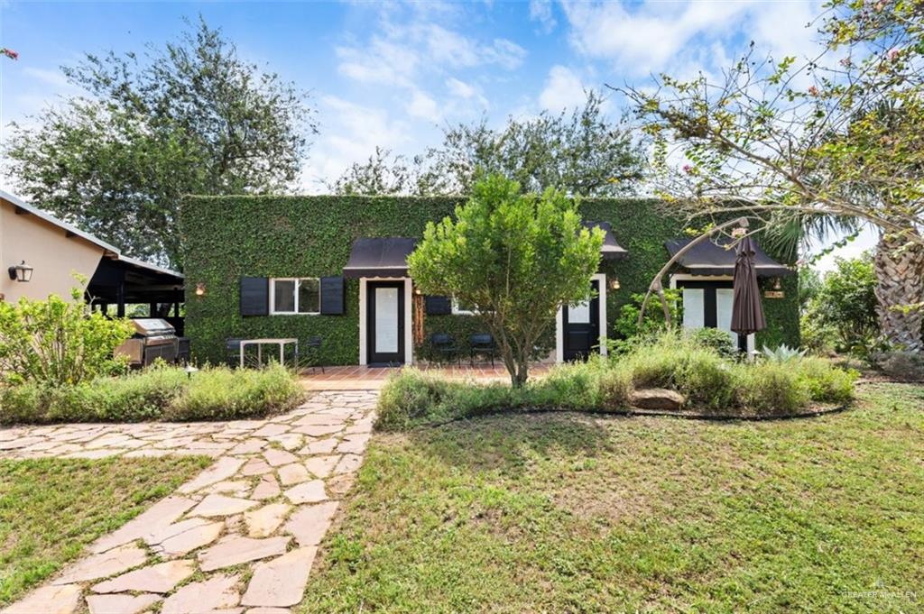 1425 Encanto Road, Unit SERVICE Weslaco, TX 78596 - Photo 38 of 45 Obstructed view of property with a front lawn and stucco siding