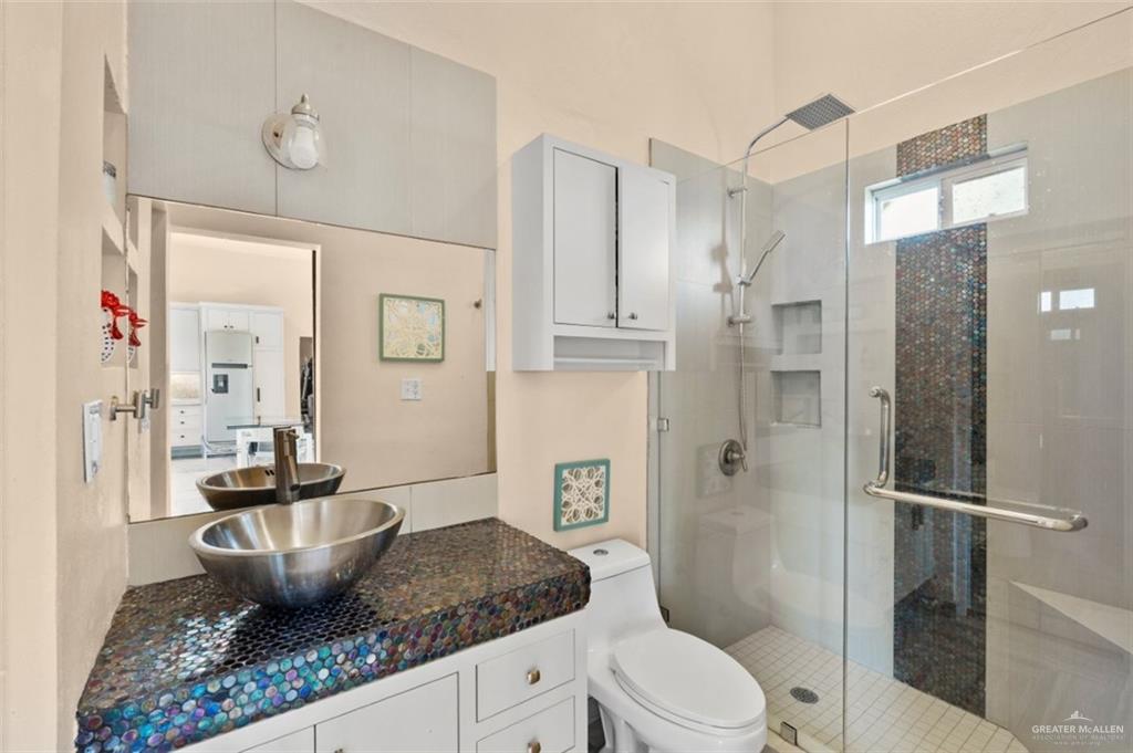 1425 Encanto Road, Unit SERVICE Weslaco, TX 78596 - Photo 39 of 45 Bathroom featuring a shower stall and vanity