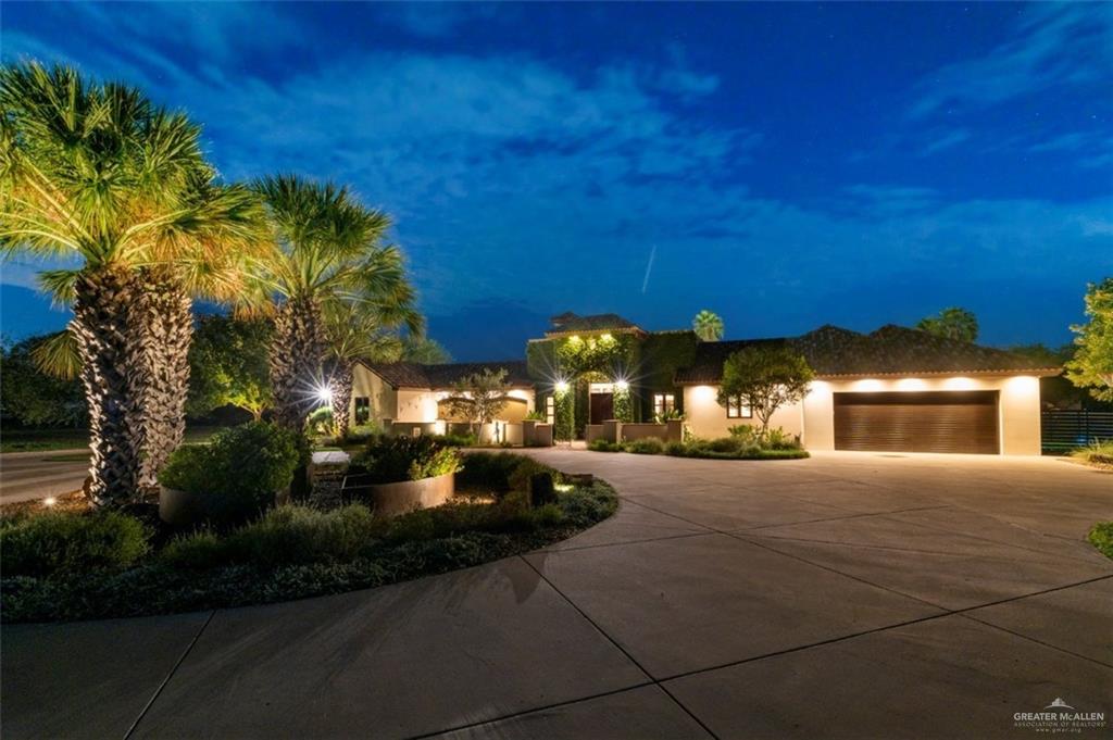 1425 Encanto Road, Unit SERVICE Weslaco, TX 78596 - Photo 9 of 45 View of front of house featuring concrete driveway, an attached garage, and stucco siding