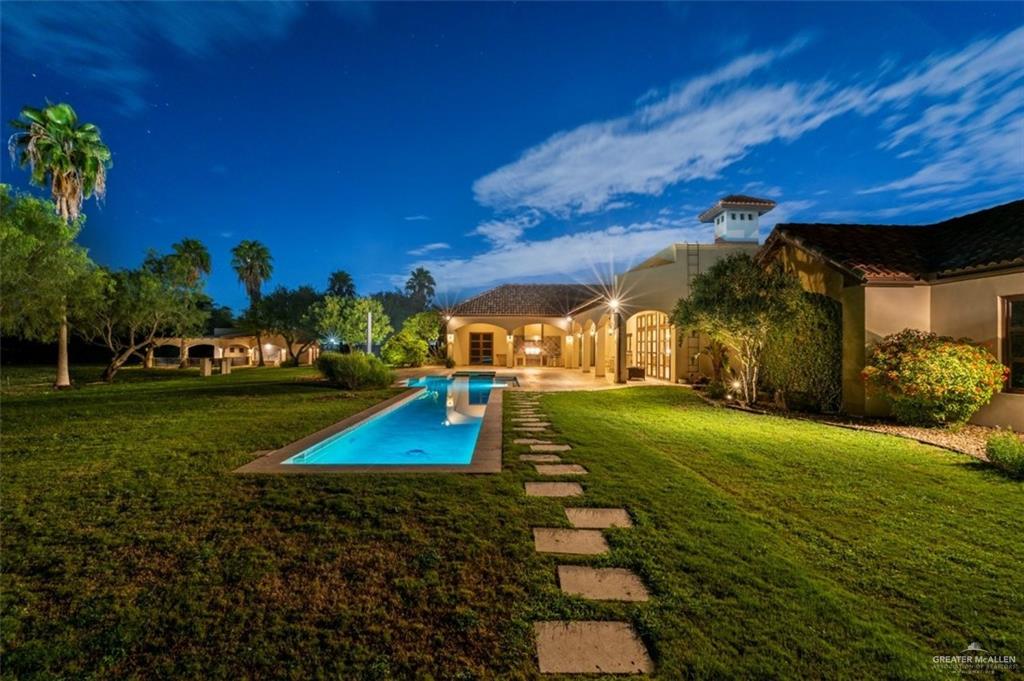 1425 Encanto Road, Unit SERVICE Weslaco, TX 78596 - Photo 10 of 45 Pool at dusk featuring a lawn, a patio, and an outdoor pool