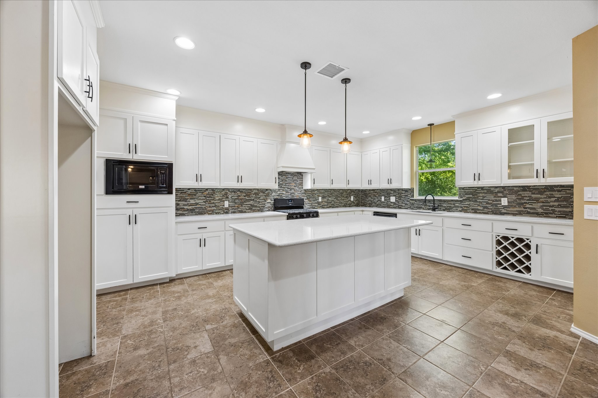 338 Spring Branch Loop Kyle, TX 78640 - Photo 6 of 36 Gleaming countertops and modern cabinetry adorn this spacious, well-lit kitchen.