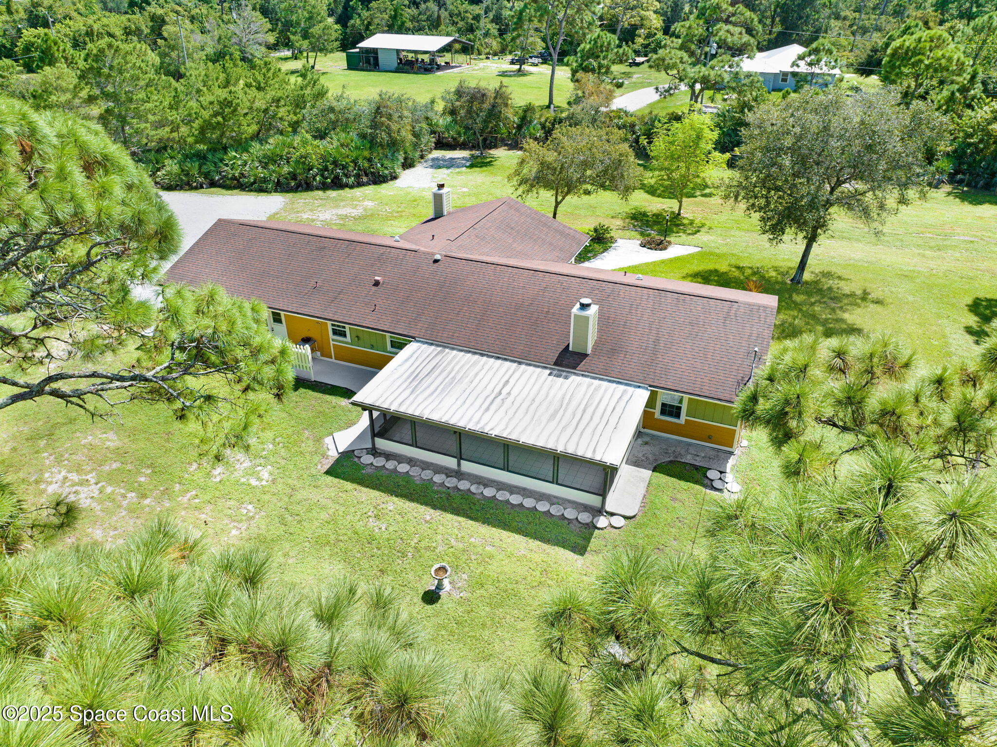 6570 Whispering Pines Lane Grant, FL 32949 - Photo 18 of 62 an aerial view of a house with garden space and trees all around