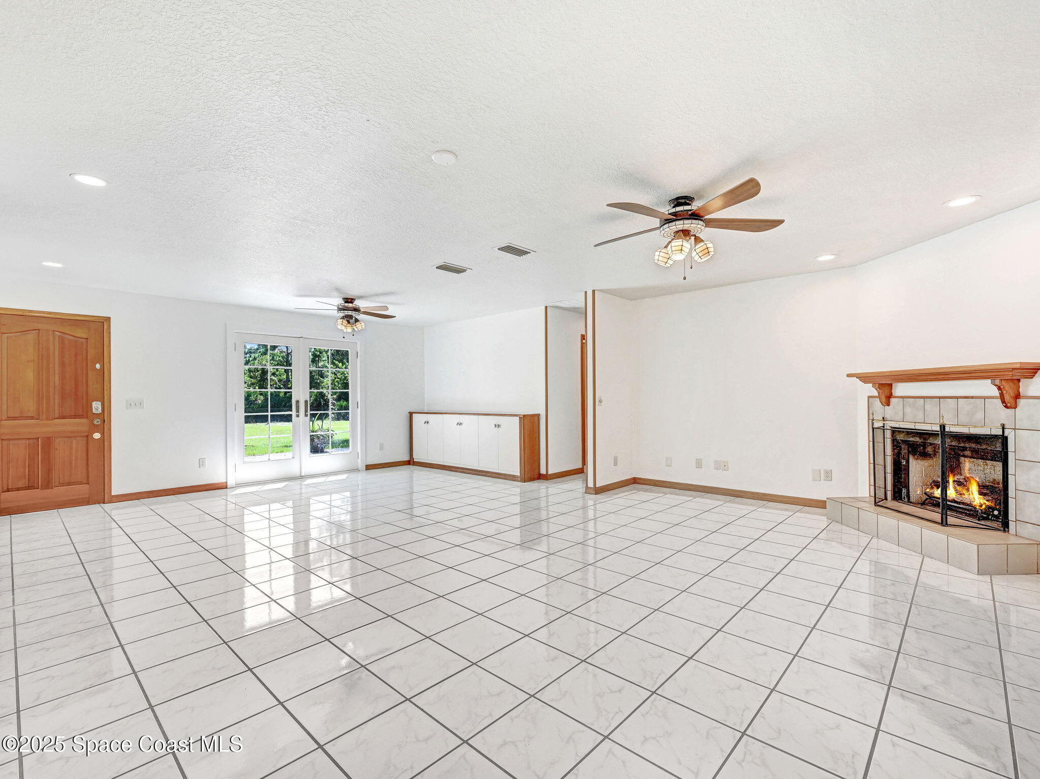 6570 Whispering Pines Lane Grant, FL 32949 - Photo 25 of 62 a view of livingroom with furniture fireplace and window