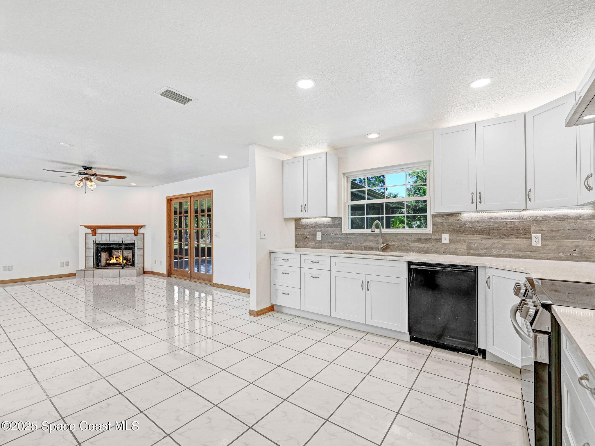 6570 Whispering Pines Lane Grant, FL 32949 - Photo 29 of 62 a kitchen with granite countertop a sink cabinets and window
