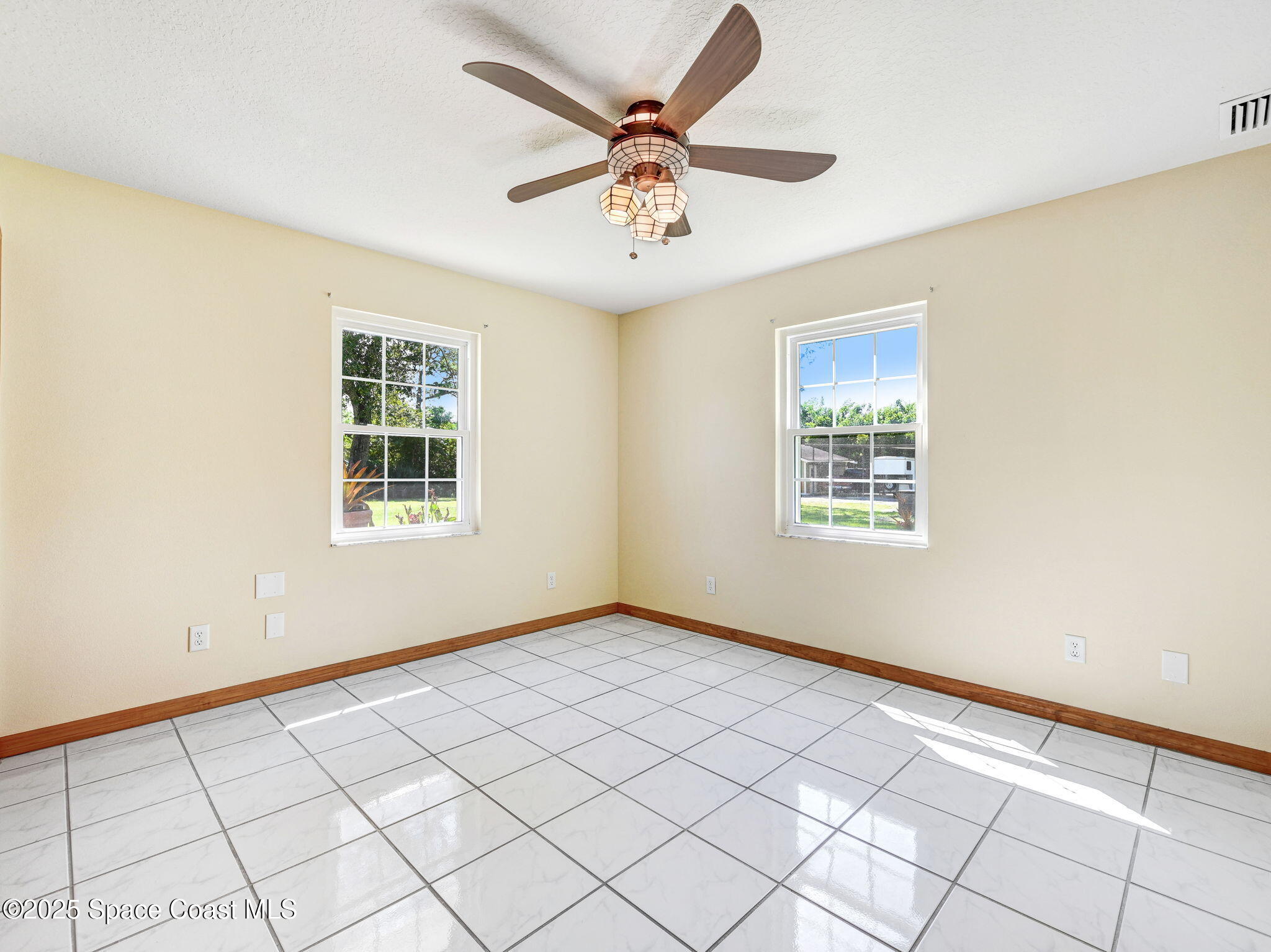 6570 Whispering Pines Lane Grant, FL 32949 - Photo 41 of 62 an empty room with windows and ceiling fan