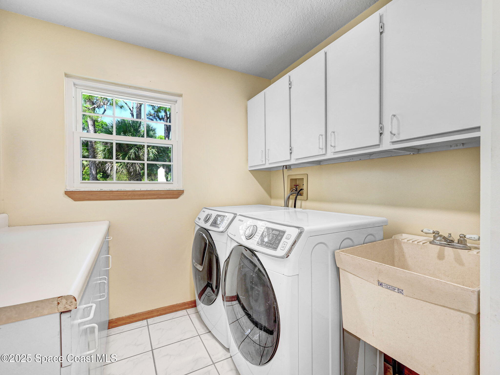 6570 Whispering Pines Lane Grant, FL 32949 - Photo 43 of 62 a utility room with dryer and washer