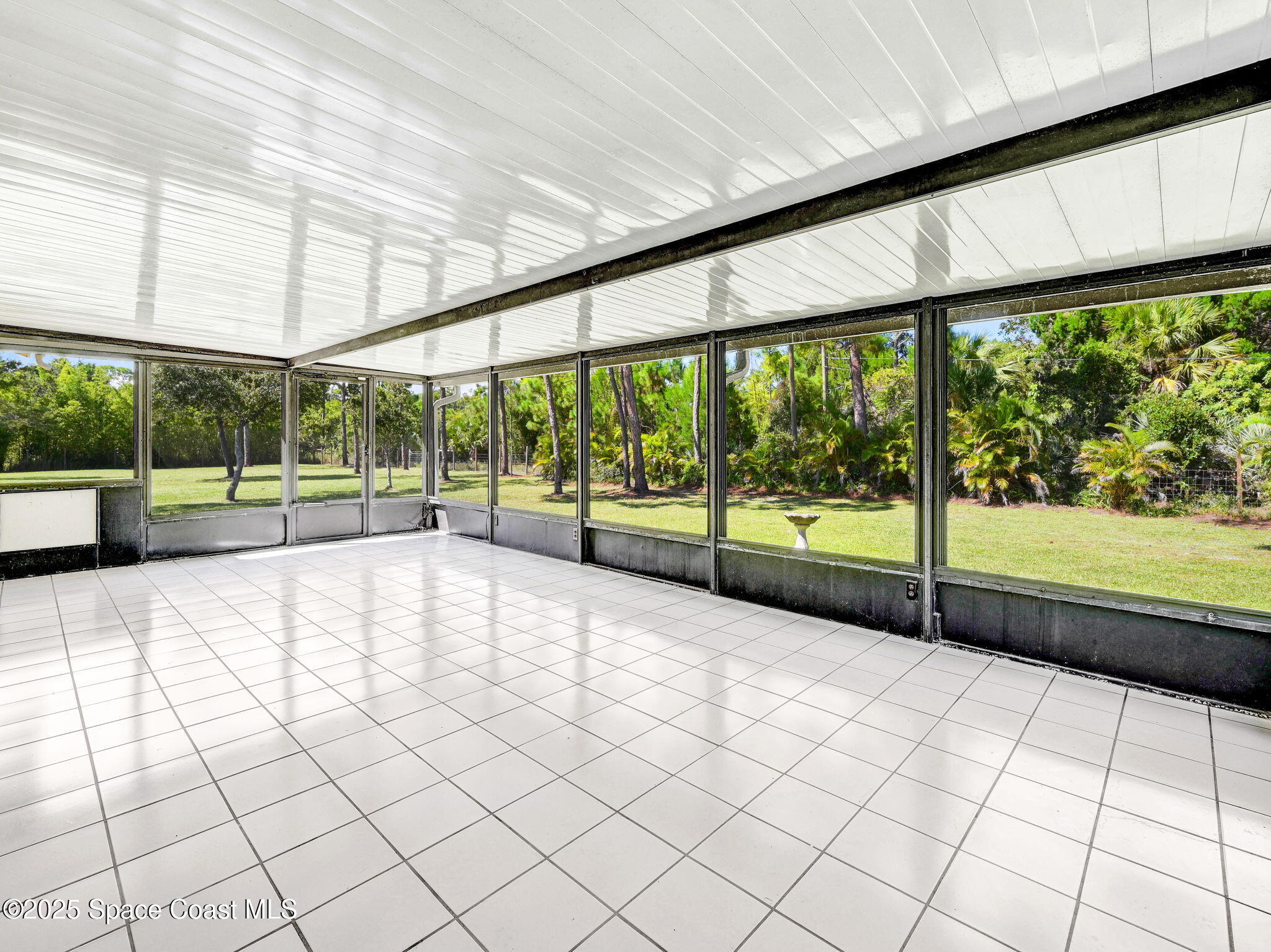 6570 Whispering Pines Lane Grant, FL 32949 - Photo 44 of 62 a view of an empty room with a floor to ceiling window