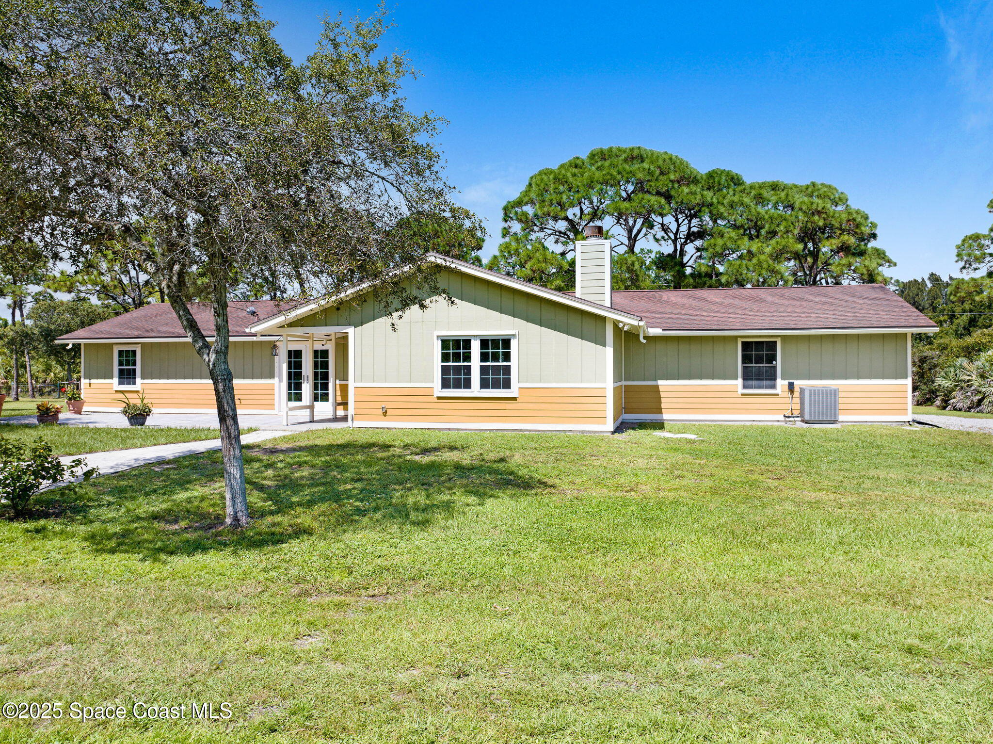 6570 Whispering Pines Lane Grant, FL 32949 - Photo 59 of 62 a house view with a garden space