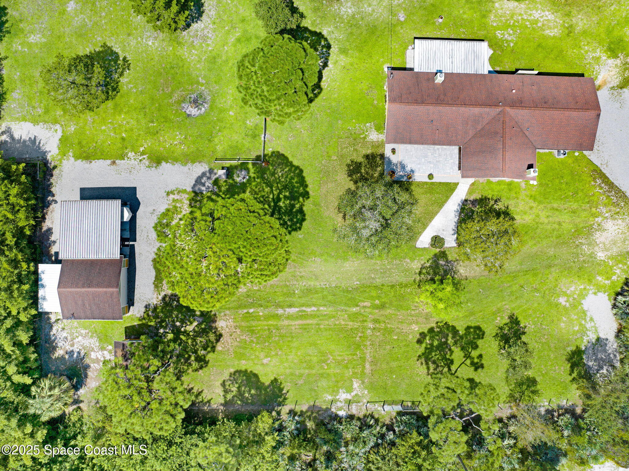 6570 Whispering Pines Lane Grant, FL 32949 - Photo 9 of 62 an aerial view of residential house with swimming pool and lawn chairs