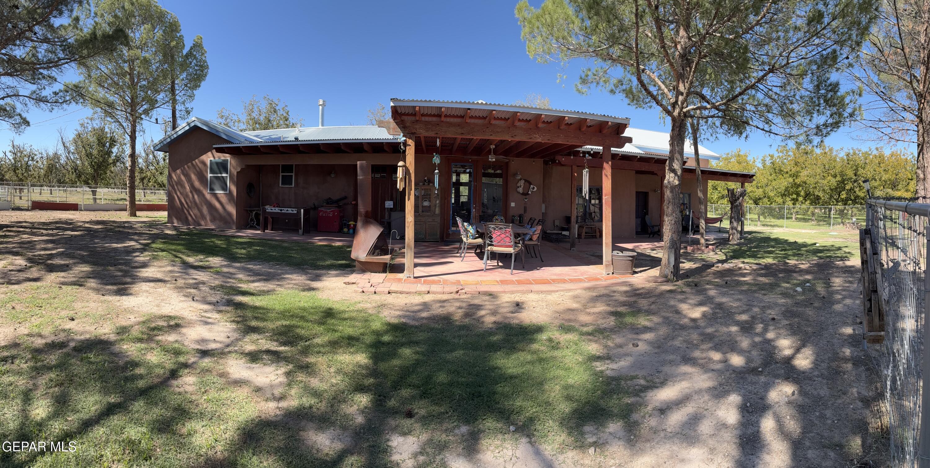 a view of a chairs and table in a backyard