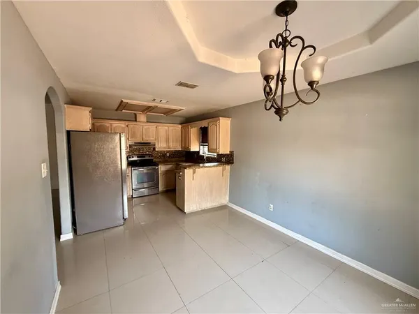 a kitchen with stainless steel appliances a refrigerator and microwave