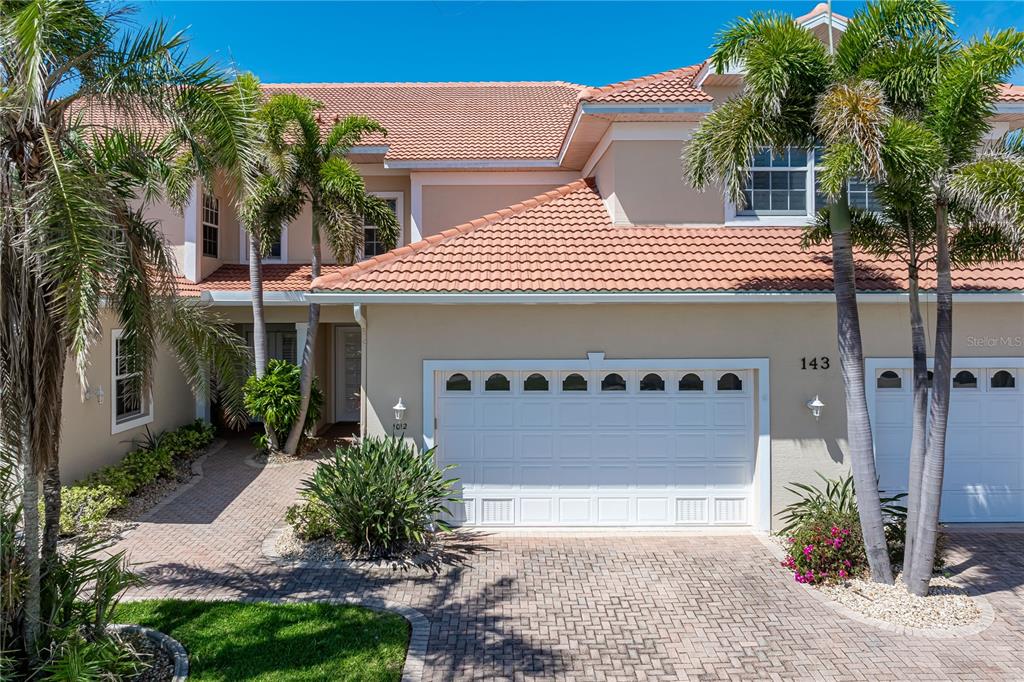 143 Tropicana Drive, Unit 1012 Punta Gorda, FL 33950 - Photo 14 of 55 a front view of a house with a garage