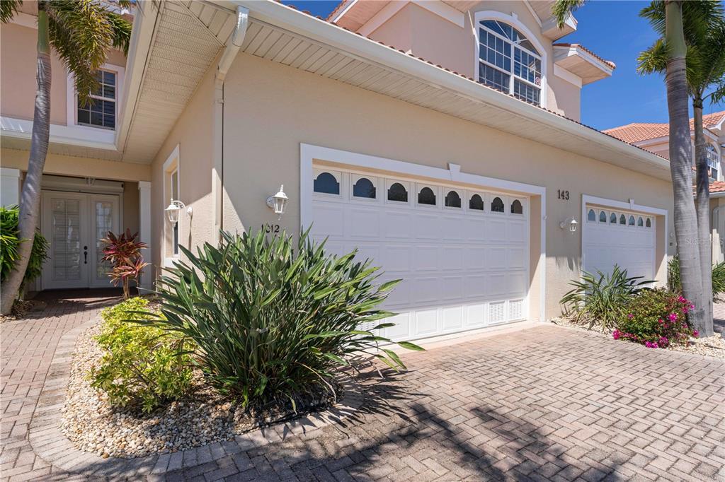 143 Tropicana Drive, Unit 1012 Punta Gorda, FL 33950 - Photo 15 of 55 a potted plant sitting in front of a building
