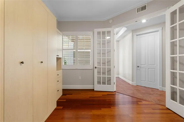 a view of empty room with wooden floor