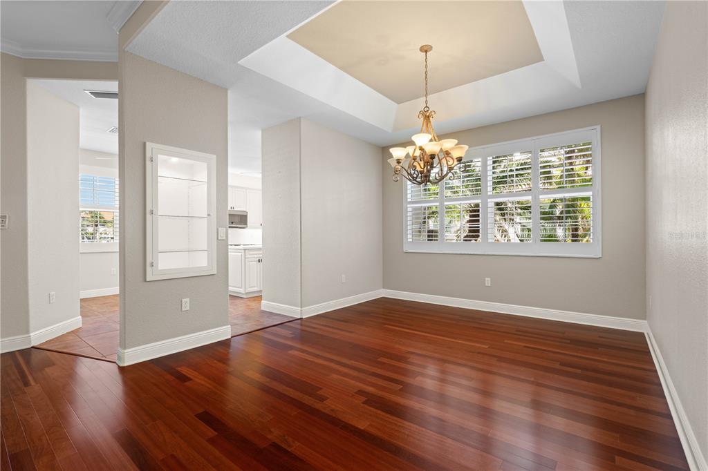 143 Tropicana Drive, Unit 1012 Punta Gorda, FL 33950 - Photo 24 of 55 an empty room with wooden floor and windows