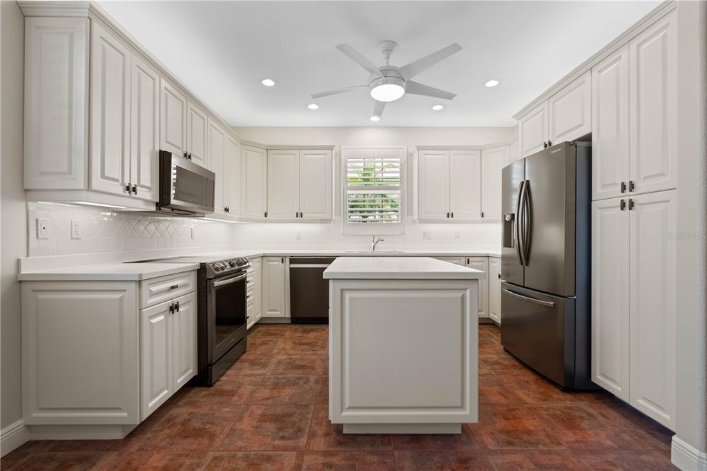 143 Tropicana Drive, Unit 1012 Punta Gorda, FL 33950 - Photo 25 of 55 a kitchen with a sink stove and refrigerator