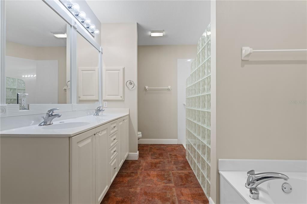 143 Tropicana Drive, Unit 1012 Punta Gorda, FL 33950 - Photo 31 of 55 a bathroom with a double vanity sink and a mirror