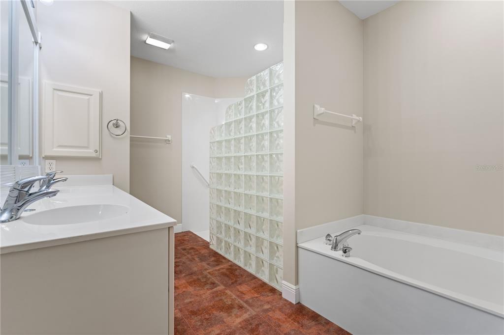 143 Tropicana Drive, Unit 1012 Punta Gorda, FL 33950 - Photo 32 of 55 a bathroom with a tub sink shower and a mirror
