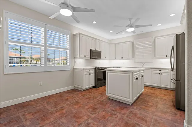a kitchen with a stove a sink and a refrigerator