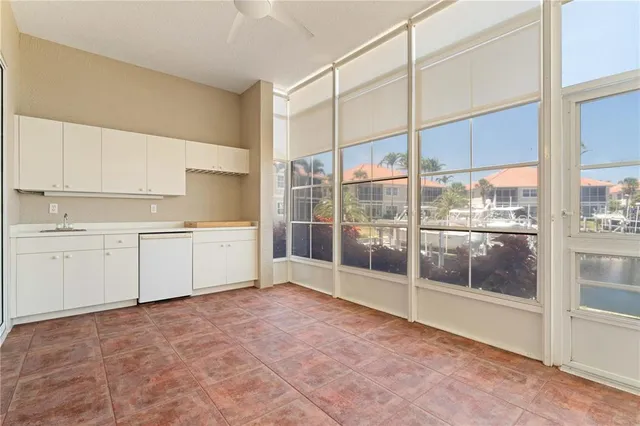 a view of a kitchen with a sink and cabinets