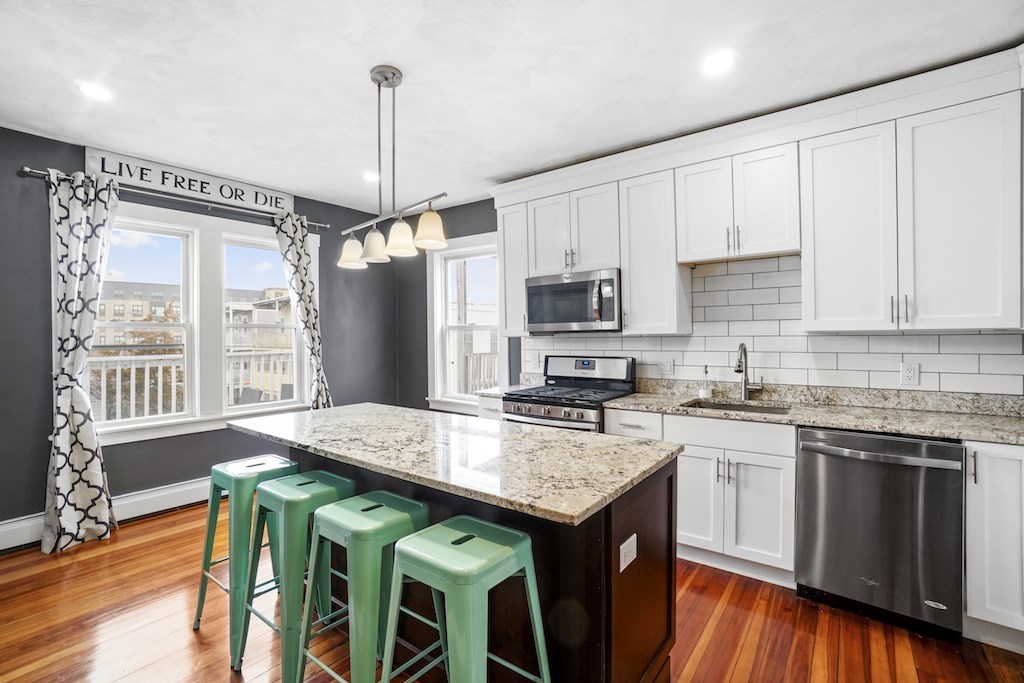 155 Boston Street, Unit 3 Boston, MA 02125 - Photo 1 of 15 a kitchen with appliances cabinets and wooden floor