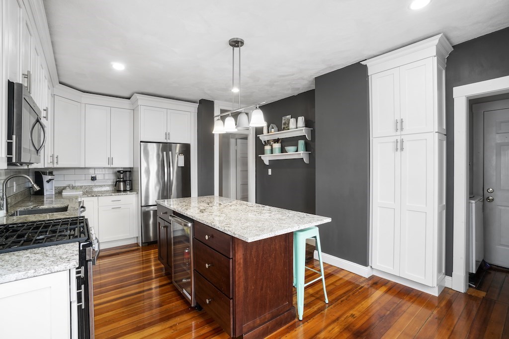 155 Boston Street, Unit 3 Boston, MA 02125 - Photo 3 of 15 a kitchen with a refrigerator a sink and wooden floor