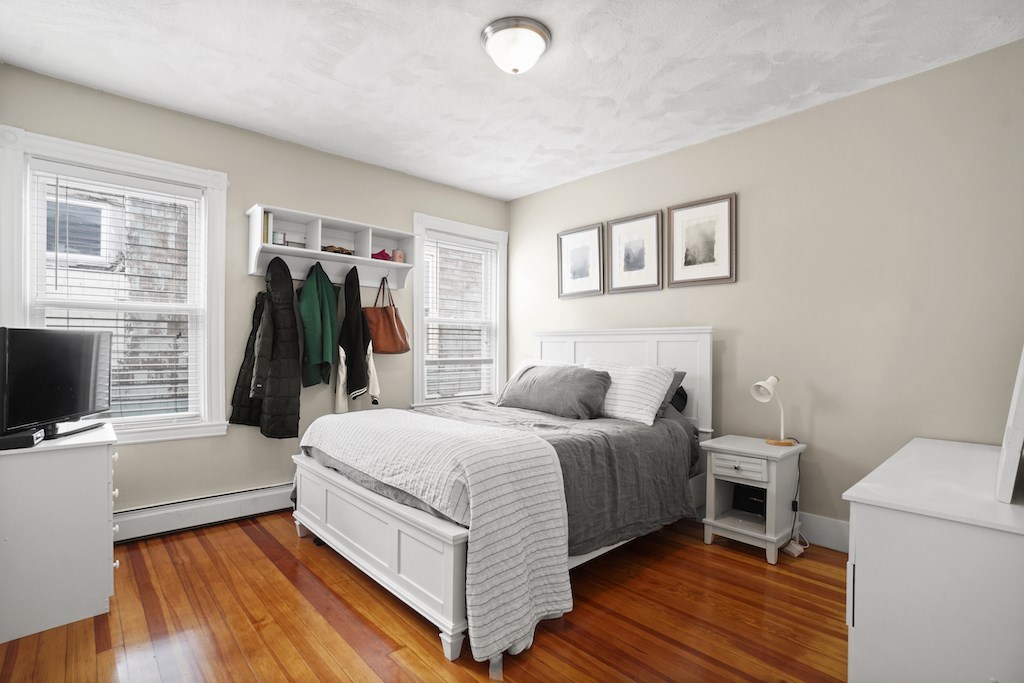 155 Boston Street, Unit 3 Boston, MA 02125 - Photo 6 of 15 a bedroom with a bed and a flat screen tv