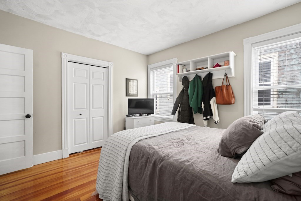 155 Boston Street, Unit 3 Boston, MA 02125 - Photo 7 of 15 a bedroom with a bed and a closet