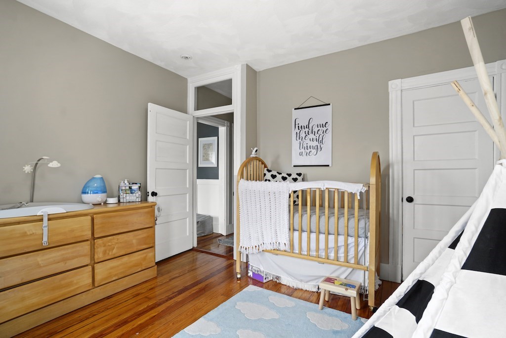 155 Boston Street, Unit 3 Boston, MA 02125 - Photo 10 of 15 a bedroom with furniture and a window