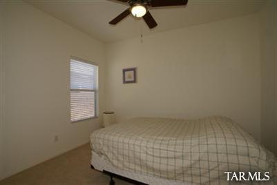 3624 East Mecate Road Tucson, AZ 85739 - Photo 16 of 17 a bed room with a bed and a window