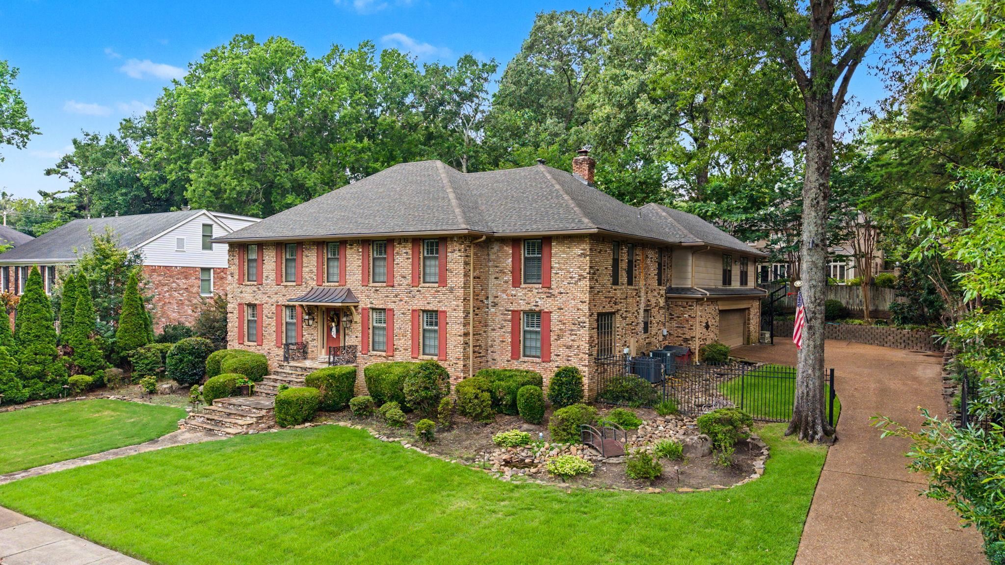 1929 Miller Farms Road Germantown, TN 38138 - Photo 1 of 40 Traditional brick exterior featuring red shutters and a covered entry