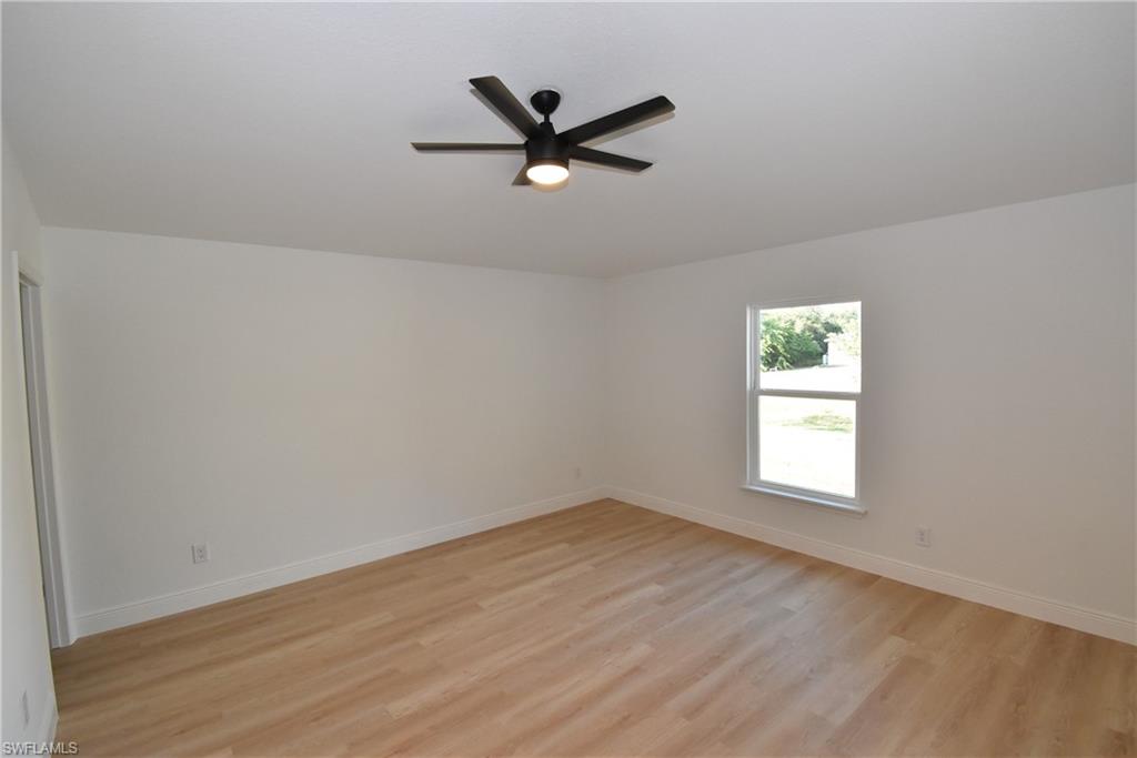 5051 Foxhall Road North Port, FL 34288 - Photo 17 of 27 an empty room with wooden floor and windows