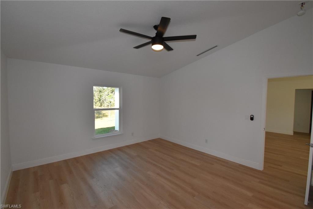 5051 Foxhall Road North Port, FL 34288 - Photo 20 of 27 an empty room with wooden floor and windows