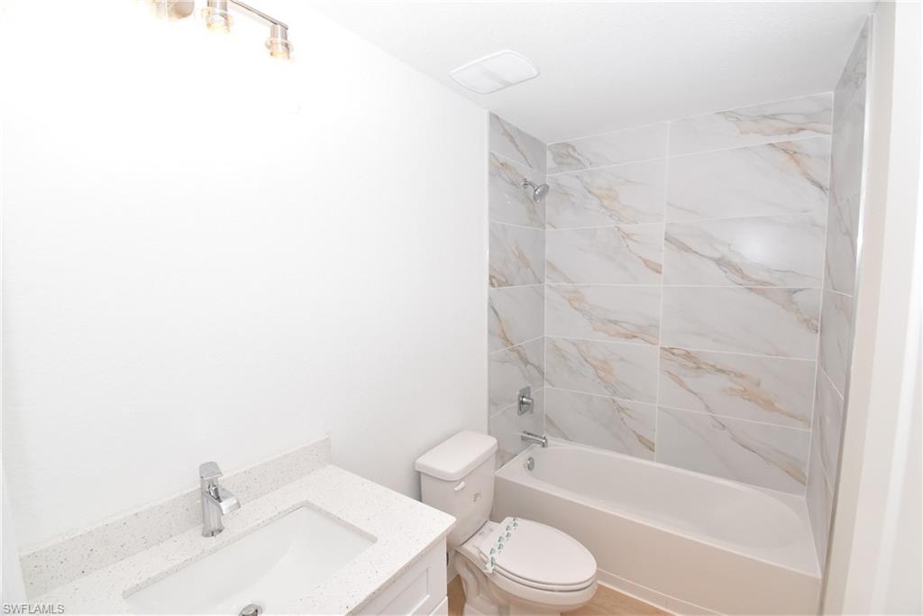 5051 Foxhall Road North Port, FL 34288 - Photo 22 of 27 a bathroom with a toilet a sink and a bathtub