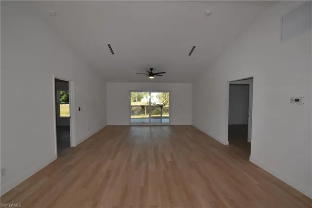 wooden floor in an empty room with a window