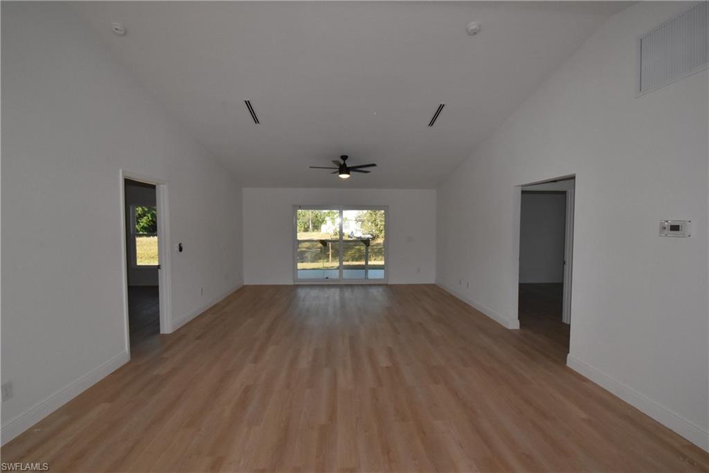 5051 Foxhall Road North Port, FL 34288 - Photo 26 of 27 wooden floor in an empty room with a window
