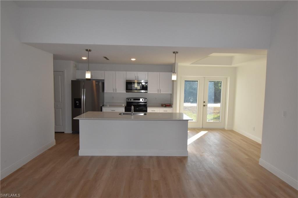 5051 Foxhall Road North Port, FL 34288 - Photo 5 of 27 a living room with stainless steel appliances kitchen island wooden floor and view living room