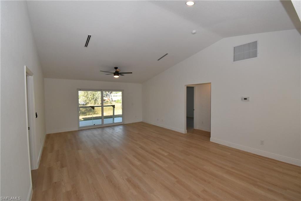 5051 Foxhall Road North Port, FL 34288 - Photo 8 of 27 an empty room with wooden floor and windows
