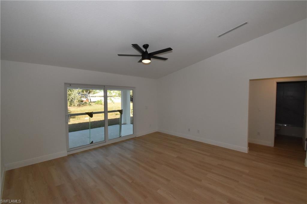 5051 Foxhall Road North Port, FL 34288 - Photo 9 of 27 wooden floor in an empty room with a window