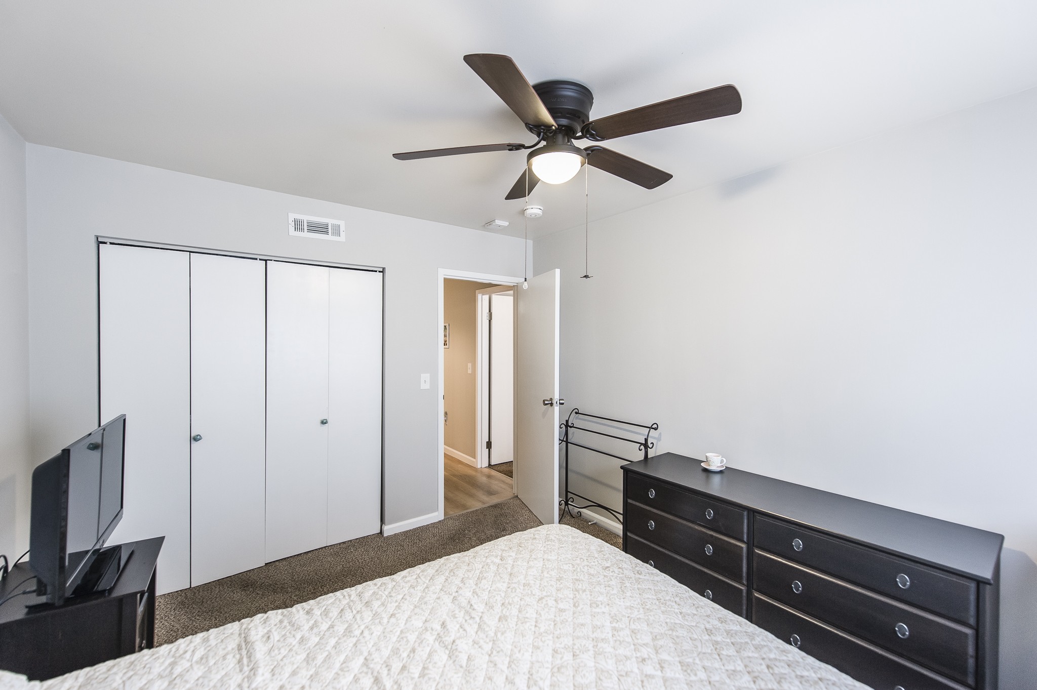 200 Sanders Ferry Road, Unit 2103 Hendersonville, TN 37075 - Photo 17 of 53 a bedroom with a bed and a flat tv screen on a dresser