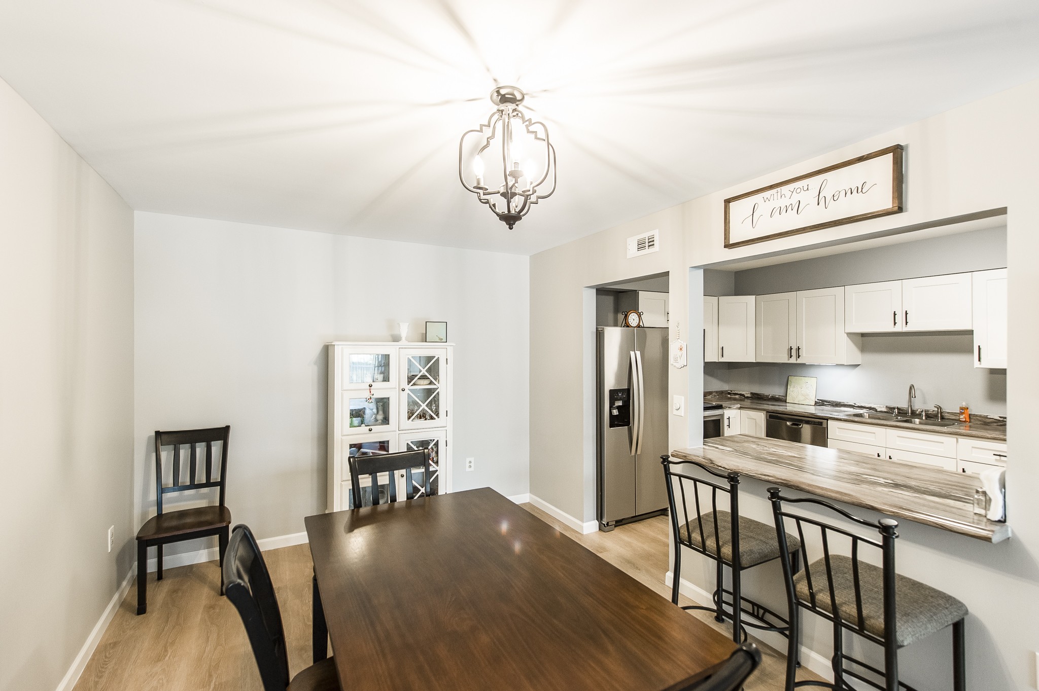200 Sanders Ferry Road, Unit 2103 Hendersonville, TN 37075 - Photo 34 of 53 a kitchen with a table chairs refrigerator and cabinets