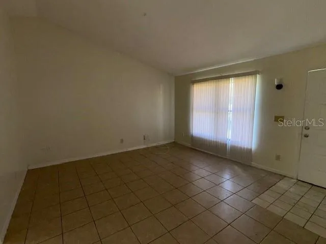 a kitchen with a stove a refrigerator and cabinets