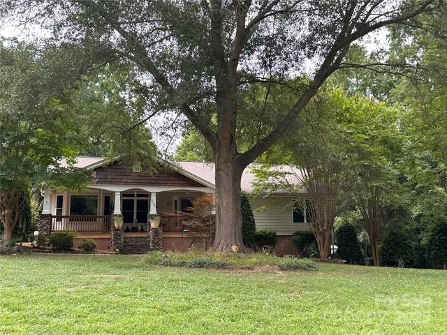 a view of a house with backyard porch and sitting area