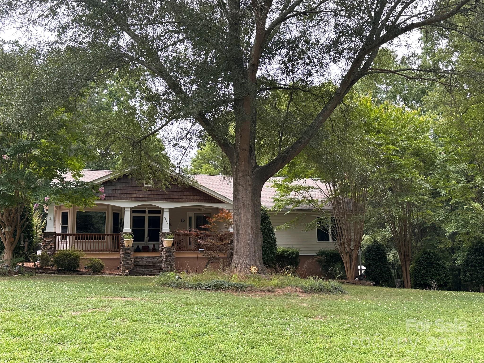 a view of a house with backyard porch and sitting area