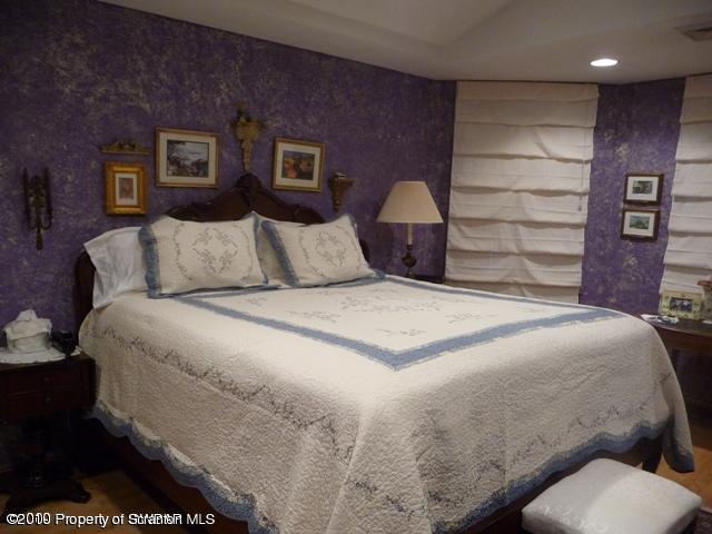 214 Willow Road Pittston, PA 18640 - Photo 13 of 19 a large bed sitting in a bedroom and painting on the wall