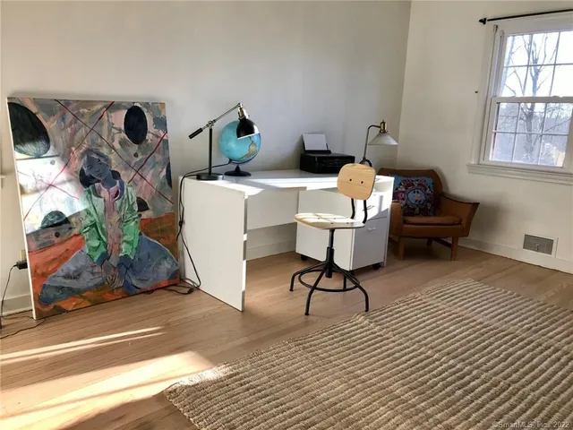 a bedroom with a bed lamp and a window