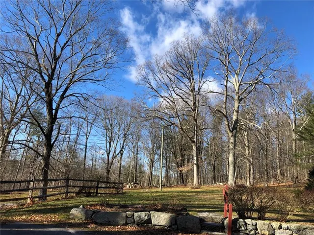 a kitchen with stainless steel appliances kitchen island granite countertop a sink dishwasher stove and refrigerator with wooden floor