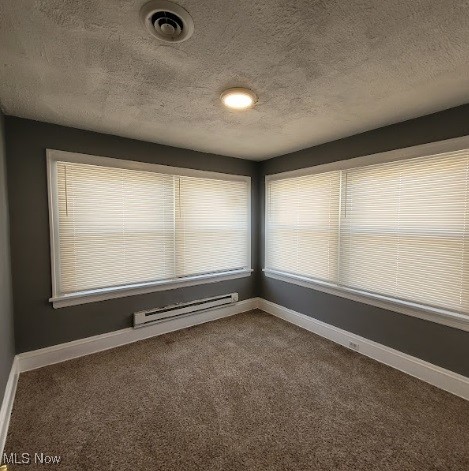 18225 Landseer Road Cleveland, OH 44119 - Photo 7 of 12 Empty room featuring a textured ceiling, dark colored carpet, and a baseboard radiator